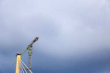 Cable-Stayed Bridge Construction with Tower Crane Under Blue Sky