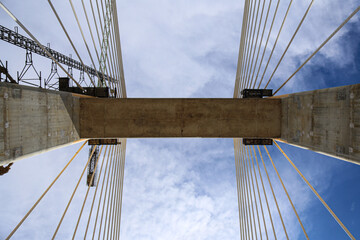 Cable-Stayed Bridge Construction with Tower Crane Under Blue Sky