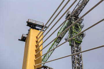 Cable-Stayed Bridge Construction with Tower Crane Under Blue Sky
