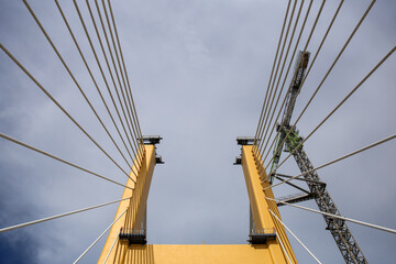 Cable-Stayed Bridge Construction with Tower Crane Under Blue Sky