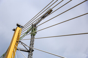 Cable-Stayed Bridge Construction with Tower Crane Under Blue Sky