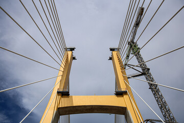 Cable-Stayed Bridge Construction with Tower Crane Under Blue Sky