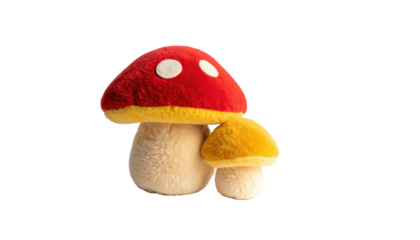 Plush toy mushrooms, one red and one yellow, with fuzzy textures against a stark black background