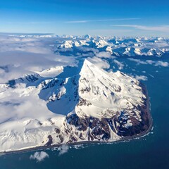 Snowy mountain touching ocean waters
