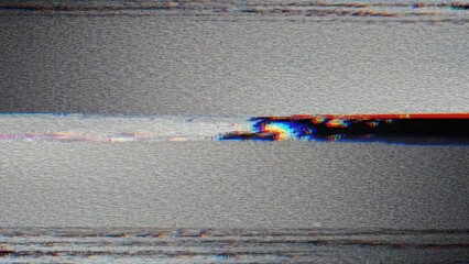 Close-up of a damaged magnetic tape with visible color fringing and deterioration.