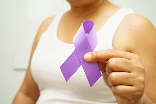 Asian woman with purple ribbon for September World pancreatic cancer day or world Alzheimer day.