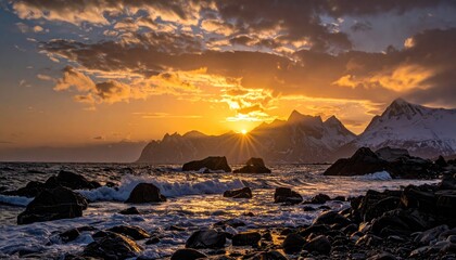 Snowy peaks meet ocean under sunset