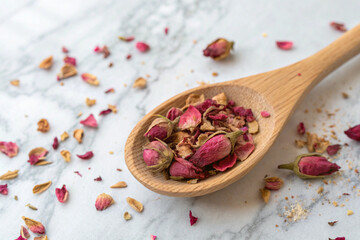 ried rose petals in-a-wooden spoon