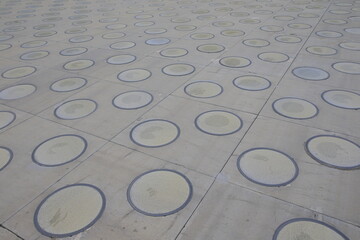 rough wet street pathway in grid pattern for design, top view. cobble granite stone,