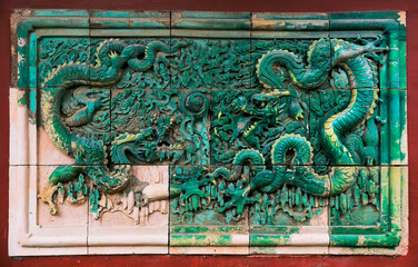 The blue glazed tiles on the wall as the background, the traditional architecture