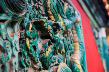 The blue glazed tiles on the wall as the background, the traditional architecture