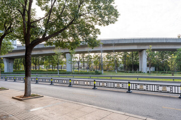Concrete structure and asphalt road space under the overpass in the city