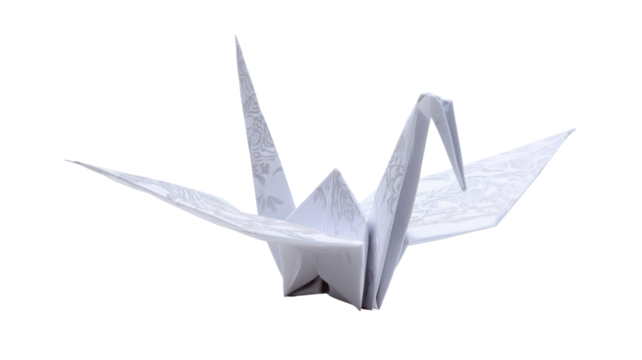White origami paper crane flying, traditional japanese art and craft symbolizing peace and hope, transparent background