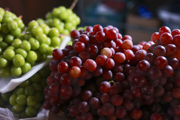 Fresh ripe red and green grape bunch vibrant and healthy fruit. Juicy and delicious food perfect for natural organic diet, showing colorful abundance at market