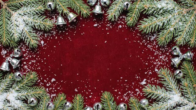 Christmas pine branches wreath border silver jingle bells white snow deep red copy space frame background use