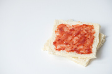 Close-up of white bread with raspberry jam