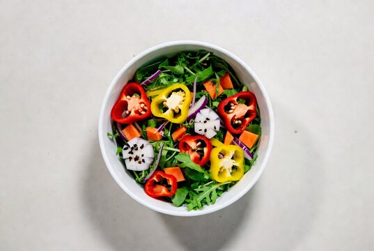 Overhead view of healthy salad with mixed greens and fresh colorful vegetables