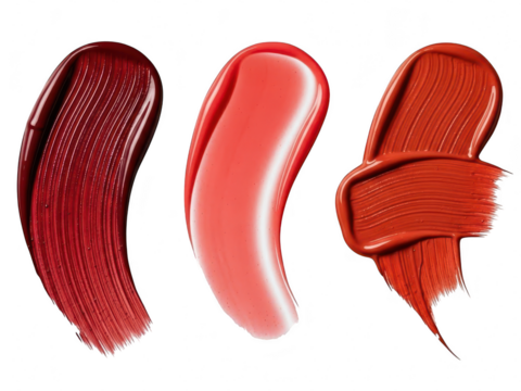 Three swatches of cosmetic lip product texture in deep red, glossy coral pink, and matte burnt orange, isolated on transparent background