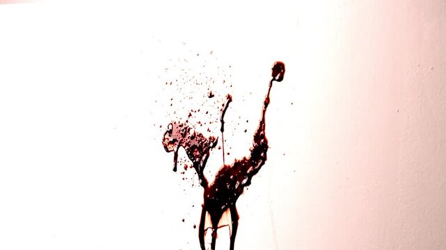Thick Dark Red Fake Blood Splattered Against White Wall. Shiny Thick Liquid Spatter Dripping. Realistic Slime Texture for Horror. Violent Crime Scene Halloween Spooky Background.