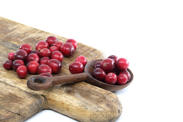 Red Cranberries on Rustic Wooden Board With Scoop. Fresh, Seasonal Holiday Garnish