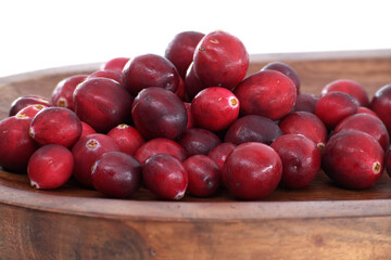 Fresh cranberries in a wooden bowl, ready for cooking or eating