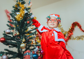 Happy a little girl with Xmas morning in decorated living room.Christmas