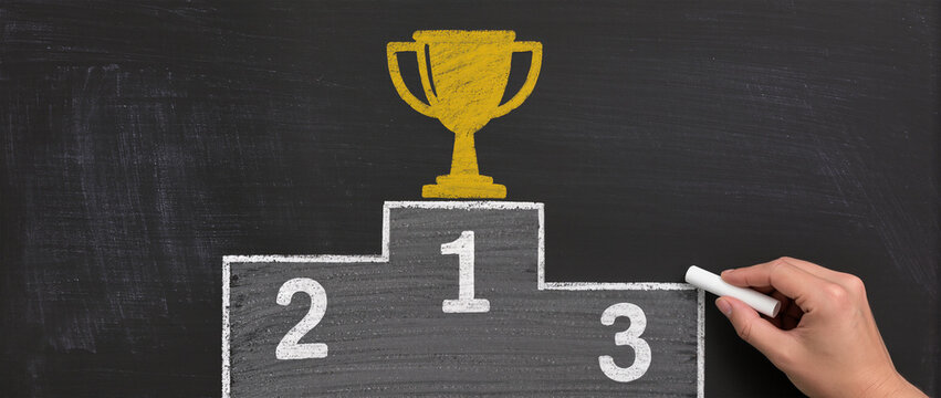 Business success concept, Businessman drawing podium and gold cup on chalkboard