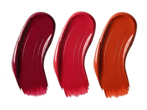 Three rich, vibrant lipstick swatches showing deep berry, bright red, and warm orange shades, isolated on transparent background