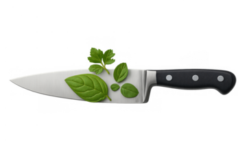 Chef's knife holding fresh cooking herbs, basil leaves and parsley on a clean, sharp blade, transparent background