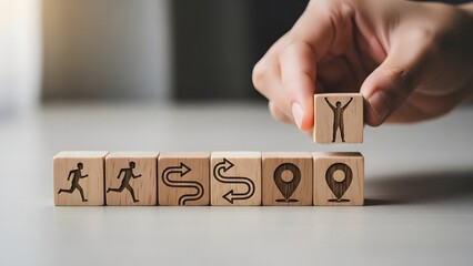 Hand placing wooden block with tree symbol on row of blocks with icons