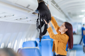 Businesswoman walking with luggage on airplane. Concept of business travel, transportation,...