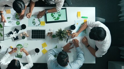 Top down view of business team discussing about using clean energy and sustainable investment at...