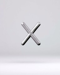 Fototapeta premium A metallic X symbol is suspended in the air against a clean white background, creating a minimalist and modern composition.