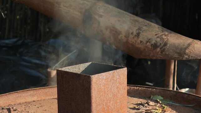 Smoke from the charcoal kiln chimney