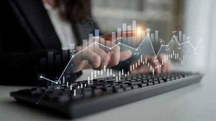 A business professional engages with data visualization on a digital interface, analyzing financial trends and performance metrics in a modern office environment. Scalp