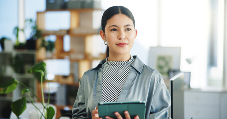 Ecology, tablet and thinking with business woman in green office for sustainability research. App, idea or planning and thoughtful person in eco friendly workplace with plants for net zero initiative