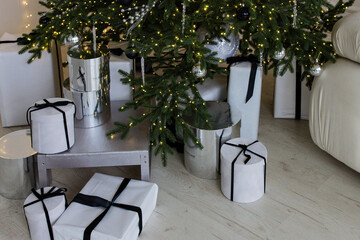 Various gifts in boxes under the New Year tree.