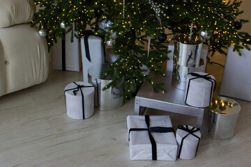 Christmas presents in light boxes under a decorated Christmas tree.