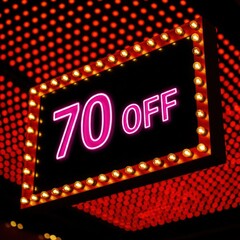 Sign with "70 OFF" in neon, surrounded by lights, on red dotted background