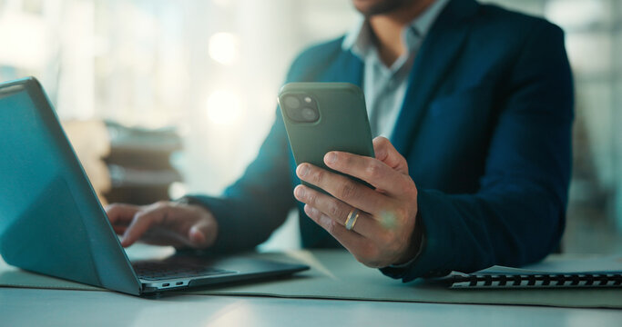 Hands, laptop and phone with business man at desk in glass office for accounting feedback. App, computer and investment management with broker typing text message in financial workplace for review