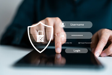 Close-up of hand using tablet with login interface and security shield icon, representing user authentication, password protection, secure access, identity verification and digital data privacy.