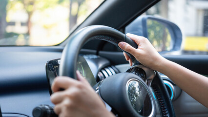 Action of a driver is gripping on steering wheel to control the car during driving. Transportation...