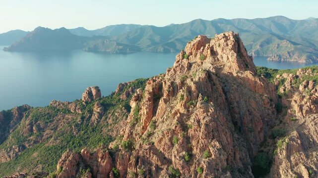 Calanques de Piana Corsica circling aerial drone view of dramatic rocky cliffs and lush Mediterranean landscape