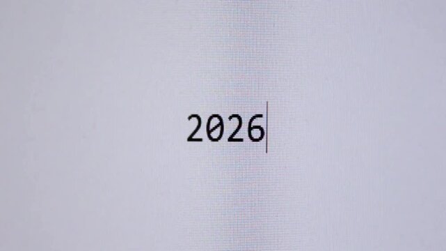The year &ldquo;2026&rdquo; appears as if typed on a clean white digital screen, representing future trends, planning, forecasts, digital timelines, and upcoming events in technology, business, and society