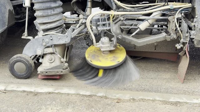 Road sweeper truck cleaning the road ahead of new tarmac work