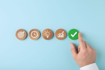 Hand pointing to a green checkmark icon, symbolizing completion of goals, time management, ideas, and growth.