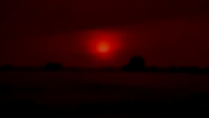 Abstract background. Early morning landscape as the weather begins to approach the end of winter 2025. Gradient of red, brown, black, and light blur. Thailand. Landscape. Sky. Rice field. Trees. Natur