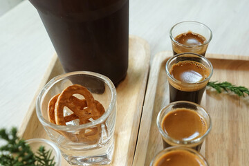 Close up Iced black Americano and espresso shots served with fresh milk and crispy mini pretzel