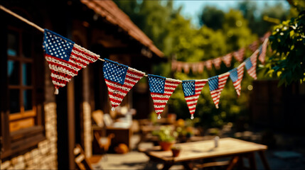 A festive outdoor setting with a wooden table and chairs decorated with a string of American flag-themed bunting