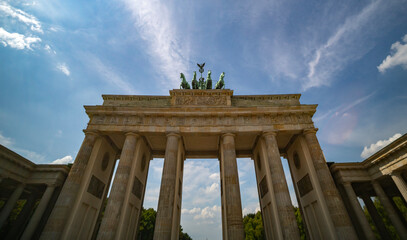 Fototapeta premium The famous Brandenburg gate in Berlin symbol of peace. Berlins landmark. Architecture in Berlin Germany. The sky glows behind the Berlin gate.